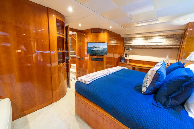  Yacht Photos Pics Luxurious bedroom interior of 1999 Azimut 100 Jumbo yacht with blue bedding.
