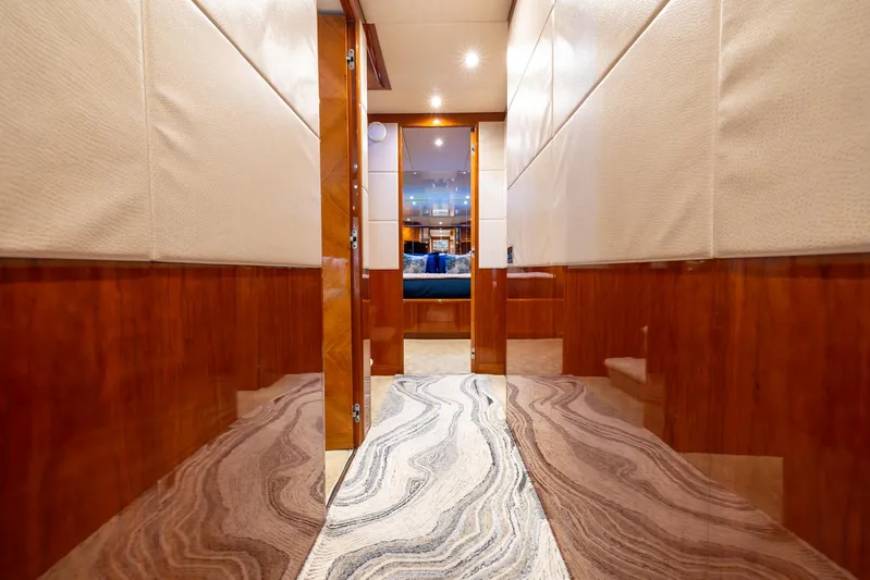  Yacht Photos Pics Luxurious hallway of a 1999 Azimut 100 Jumbo yacht with elegant wood paneling.