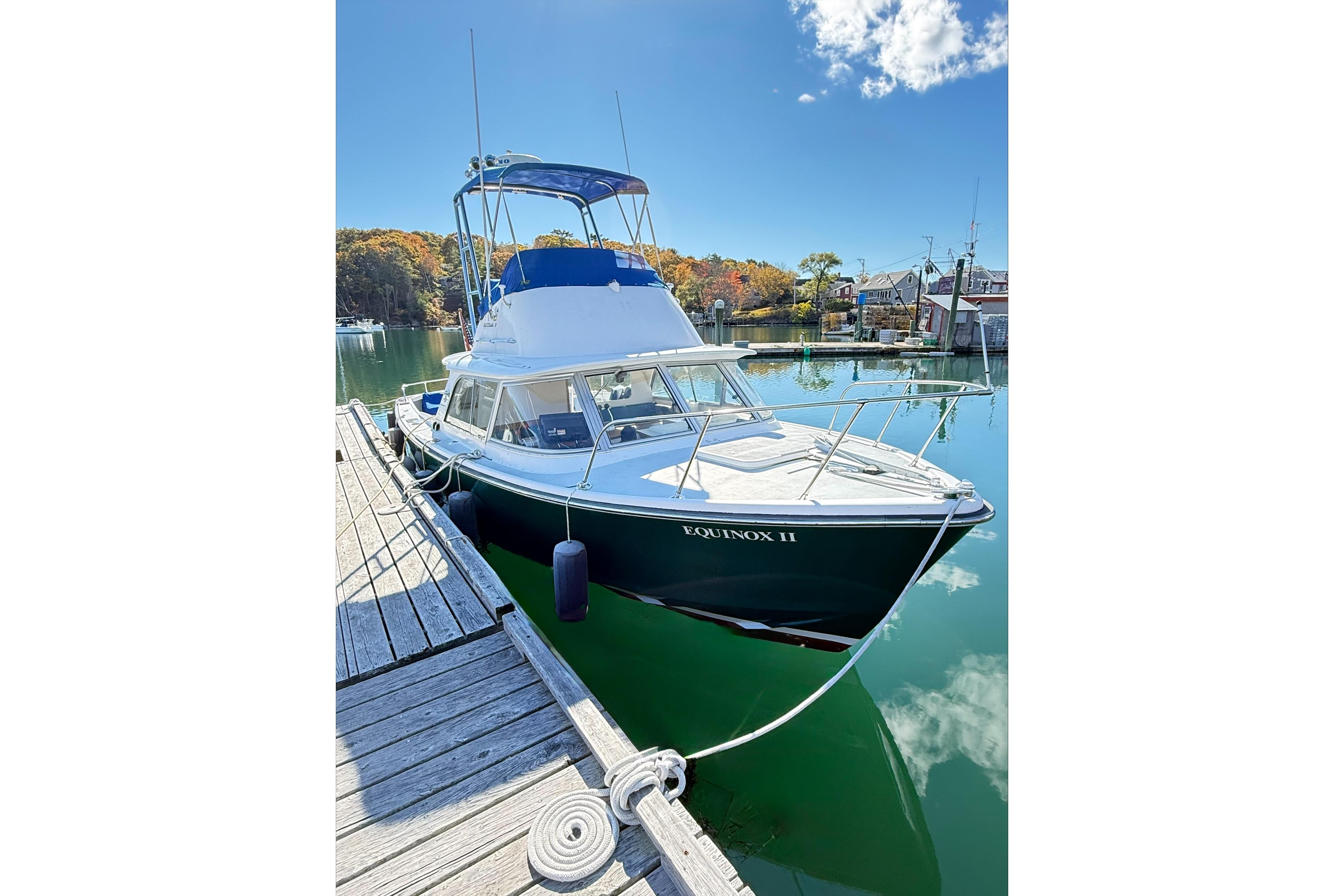 1963 Bertram 31 Flybridge Cruiser docked on a sunny day.