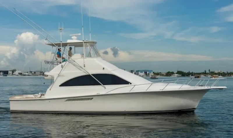Loon Atik Yacht Photos Pics 2005 Ocean Yachts 46 Super Sport cruising on calm waters under a clear sky.