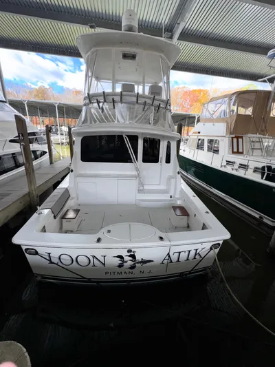 Loon Atik Yacht Photos Pics 2005 Ocean Yachts 46 Super Sport docked in a marina, rear view.