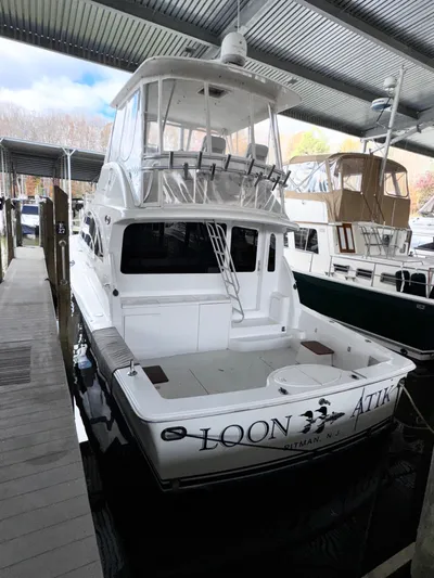 Loon Atik Yacht Photos Pics 2005 Ocean Yachts 46 Super Sport docked under a covered marina.