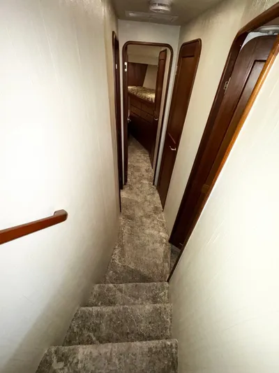 Loon Atik Yacht Photos Pics Narrow hallway with carpeted stairs inside 2005 Ocean Yachts 46 Super Sport.