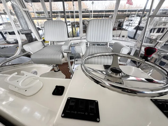 Loon Atik Yacht Photos Pics Helm of 2005 Ocean Yachts 46 Super Sport with dual captain chairs and steering wheel.