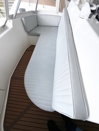 Loon Atik Yacht Photos Pics Interior seating of 2005 Ocean Yachts 46 Super Sport with white cushions and wooden flooring.