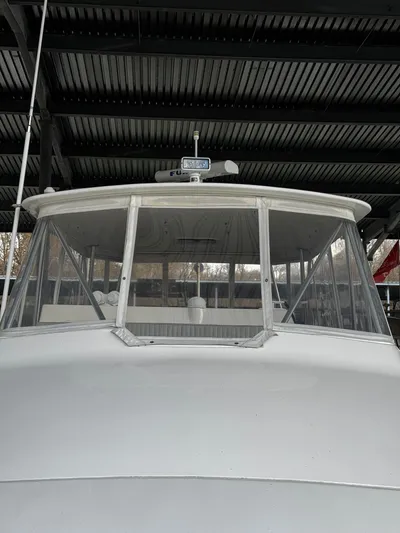 Loon Atik Yacht Photos Pics 2005 Ocean Yachts 46 Super Sport boat under a covered dock.