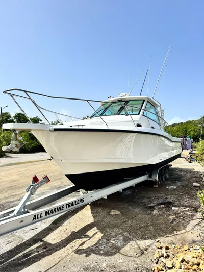  Yacht Photos Pics 2012 Boston Whaler 345 Conquest boat on a trailer in a sunny outdoor setting.