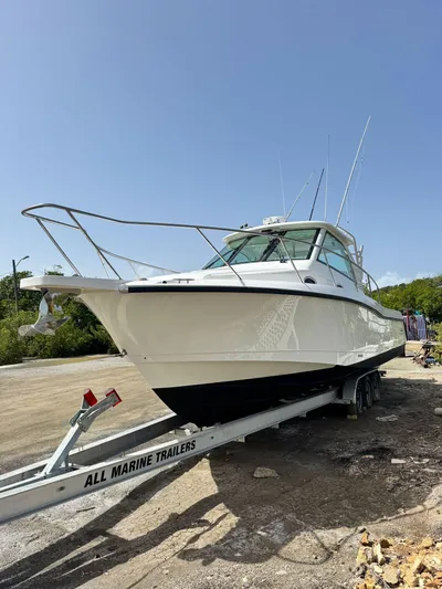  Yacht Photos Pics 2012 Boston Whaler 345 Conquest on a trailer in a sunny outdoor setting.