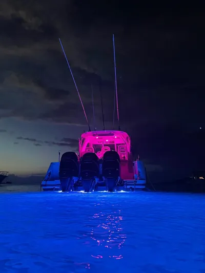  Yacht Photos Pics Boston Whaler 345 Conquest 2012 with vibrant night lighting on the water.