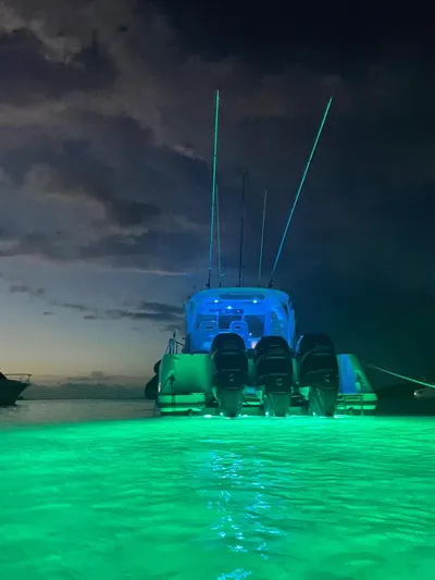  Yacht Photos Pics Boston Whaler 345 Conquest 2012 boat with glowing green underwater lights at night.