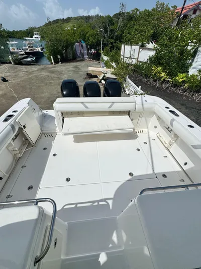  Yacht Photos Pics 2012 Boston Whaler 345 Conquest boat with triple outboard engines, docked on land.