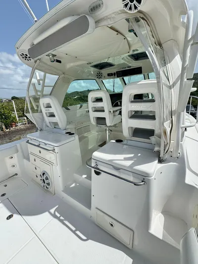  Yacht Photos Pics 2012 Boston Whaler 345 Conquest cockpit with white seating and control panel.