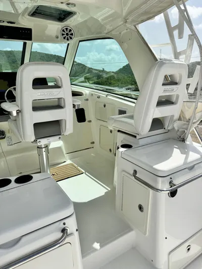  Yacht Photos Pics Interior of a 2012 Boston Whaler 345 Conquest boat with white seating and helm.