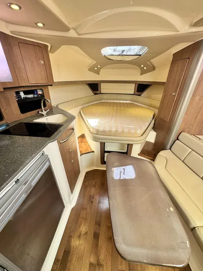  Yacht Photos Pics 2012 Boston Whaler 345 Conquest cabin interior with kitchenette and seating area.