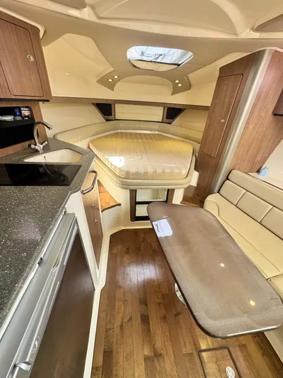  Yacht Photos Pics 2012 Boston Whaler 345 Conquest cabin interior with kitchen, seating, and bed.