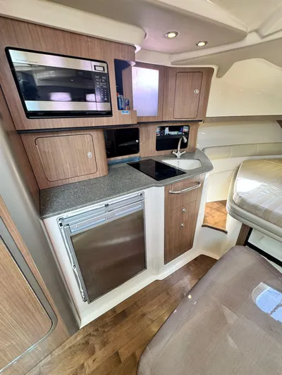  Yacht Photos Pics 2012 Boston Whaler 345 Conquest galley with microwave, sink, and refrigerator.