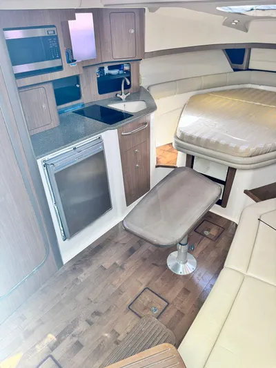  Yacht Photos Pics 2012 Boston Whaler 345 Conquest cabin interior with kitchenette and seating area.