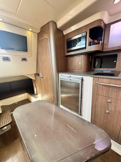  Yacht Photos Pics 2012 Boston Whaler 345 Conquest cabin interior with kitchenette and seating area.