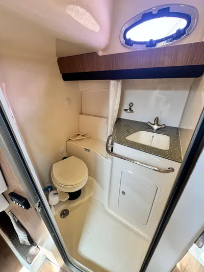  Yacht Photos Pics Compact bathroom in 2012 Boston Whaler 345 Conquest boat with sink and toilet.