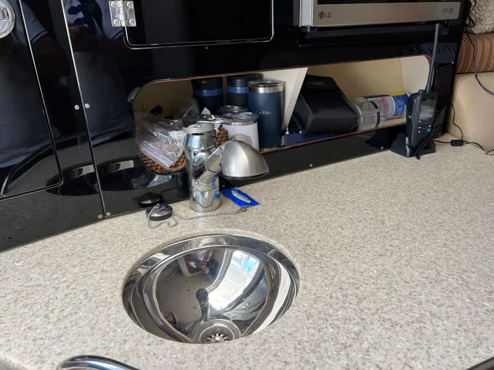 Pura Vida Yacht Photos Pics 2008 Hydra-Sports Vector 3500 VX galley with sink, countertop, and storage shelves.