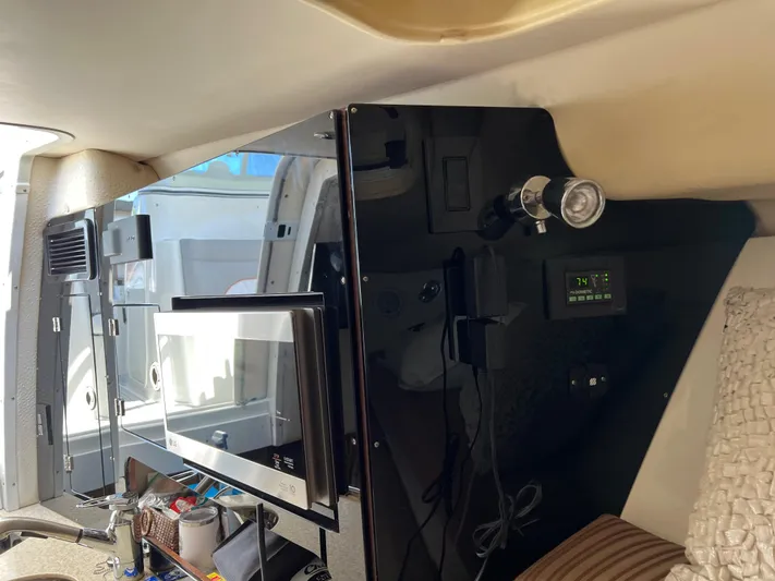 Pura Vida Yacht Photos Pics Interior of 2008 Hydra-Sports Vector 3500 VX with microwave and control panel.