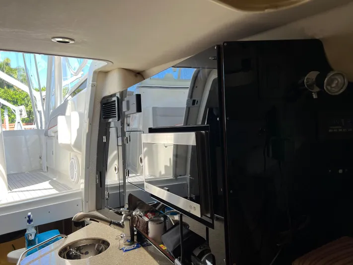 Pura Vida Yacht Photos Pics Interior of 2008 Hydra-Sports Vector 3500 VX boat with kitchenette and microwave.