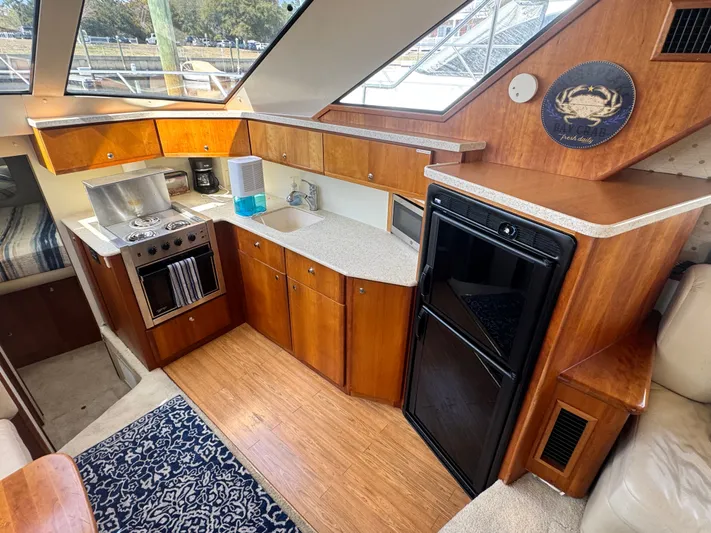 Why Wait Yacht Photos Pics Interior of 2000 Silverton 392 Motor Yacht featuring kitchen area.