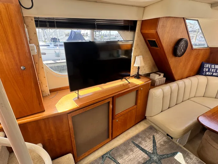 Why Wait Yacht Photos Pics Interior of a 2000 Silverton 392 Motor Yacht with TV and sofa.