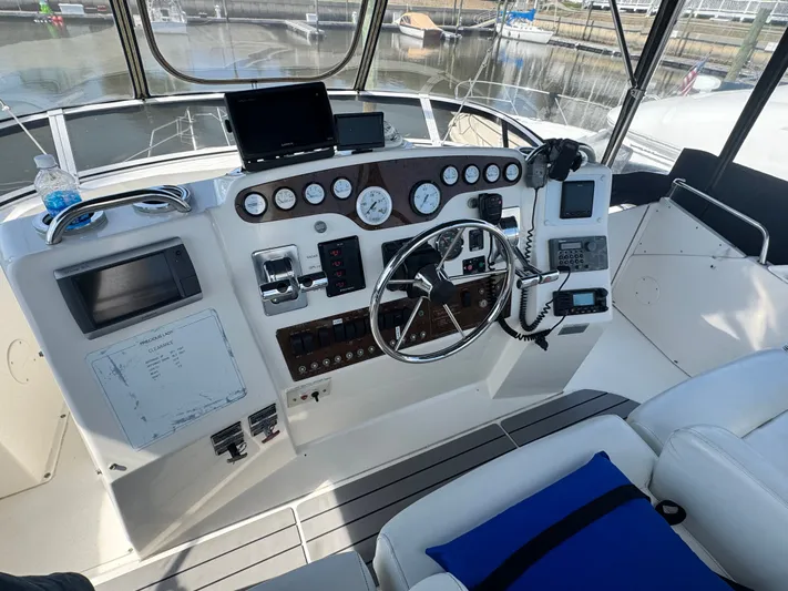 Why Wait Yacht Photos Pics 2000 Silverton 392 Motor Yacht helm station in harbor.