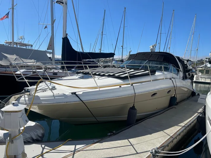  Yacht Photos Pics 2005 Sea Ray 390 Sundancer yacht docked at marina under clear blue sky.