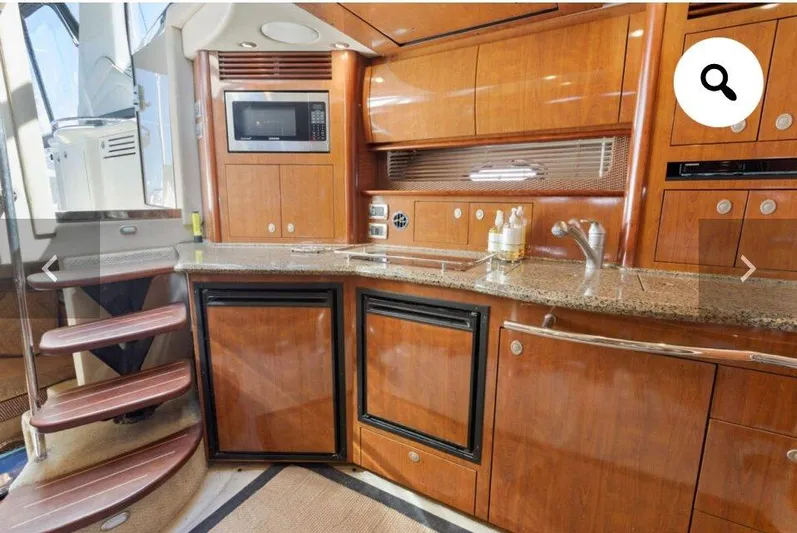  Yacht Photos Pics Luxurious 2005 Sea Ray 390 Sundancer yacht kitchen with wood cabinetry and modern appliances.