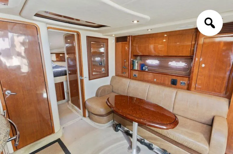  Yacht Photos Pics Interior of 2005 Sea Ray 390 Sundancer yacht with wooden cabinetry and beige seating.