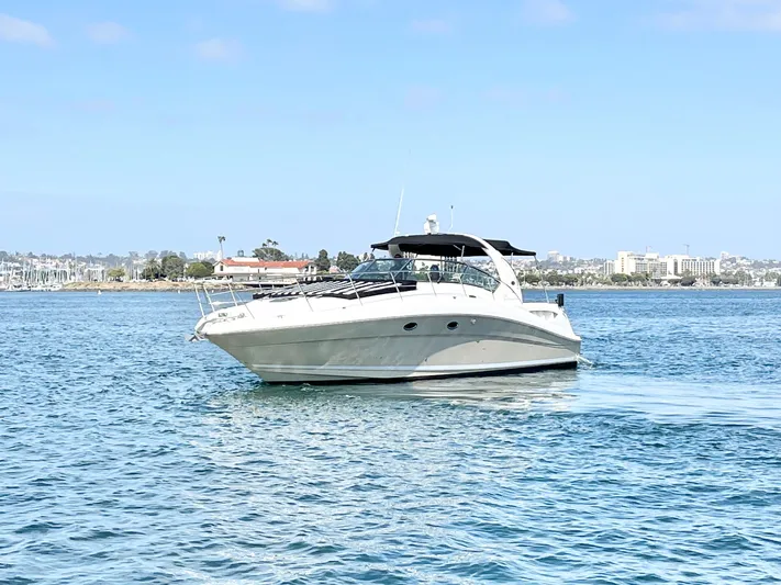  Yacht Photos Pics 2005 Sea Ray 390 Sundancer yacht cruising on calm blue waters.