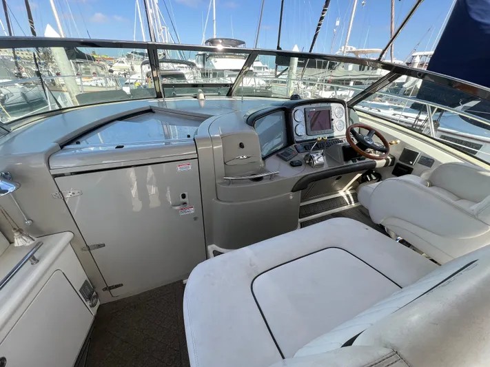 Yacht Photos Pics 2005 Sea Ray 390 Sundancer helm with modern controls and comfortable seating in a marina setting.