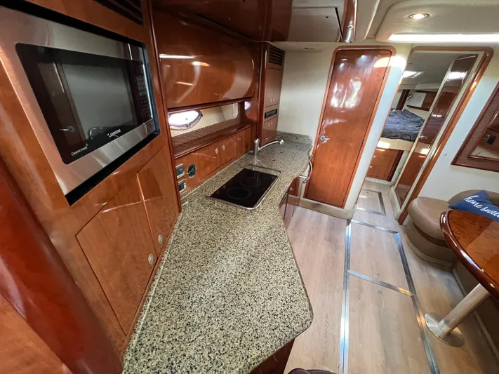  Yacht Photos Pics Luxurious 2005 Sea Ray 390 Sundancer yacht interior with modern kitchen and cozy cabin.