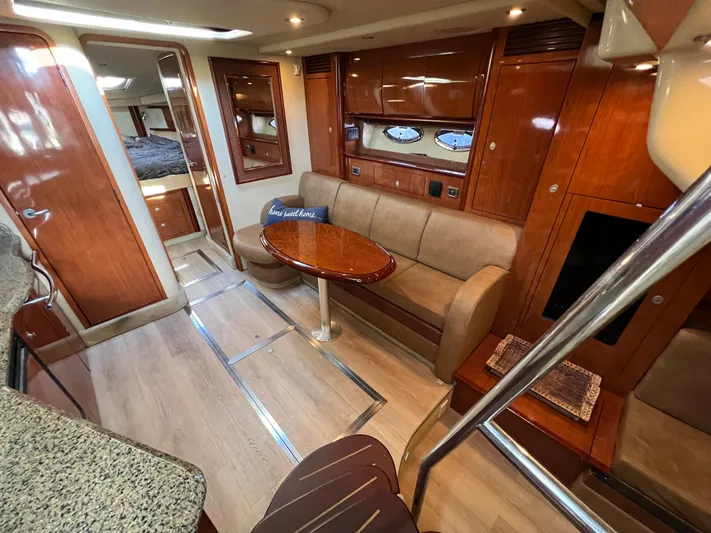  Yacht Photos Pics Luxurious interior of 2005 Sea Ray 390 Sundancer yacht with wood finishes and cozy seating.