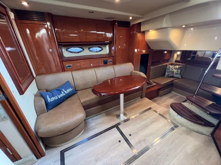  Yacht Photos Pics Luxurious interior of 2005 Sea Ray 390 Sundancer yacht with elegant seating and wooden finishes.