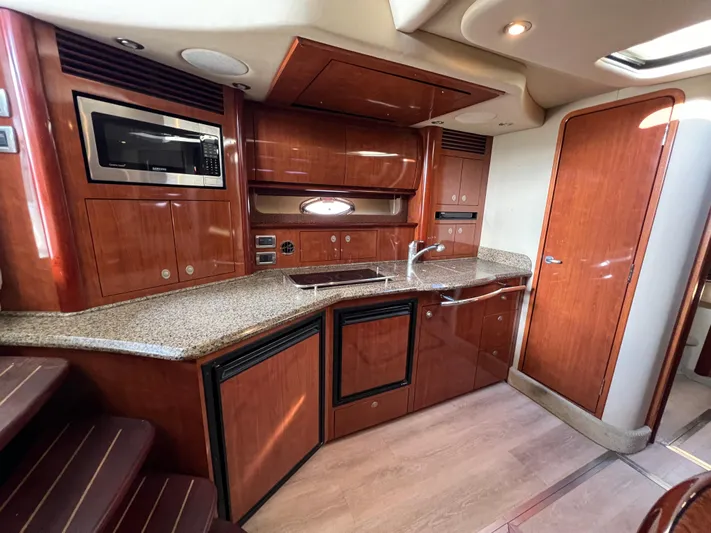  Yacht Photos Pics Luxurious 2005 Sea Ray 390 Sundancer yacht kitchen with wood cabinetry and modern appliances.