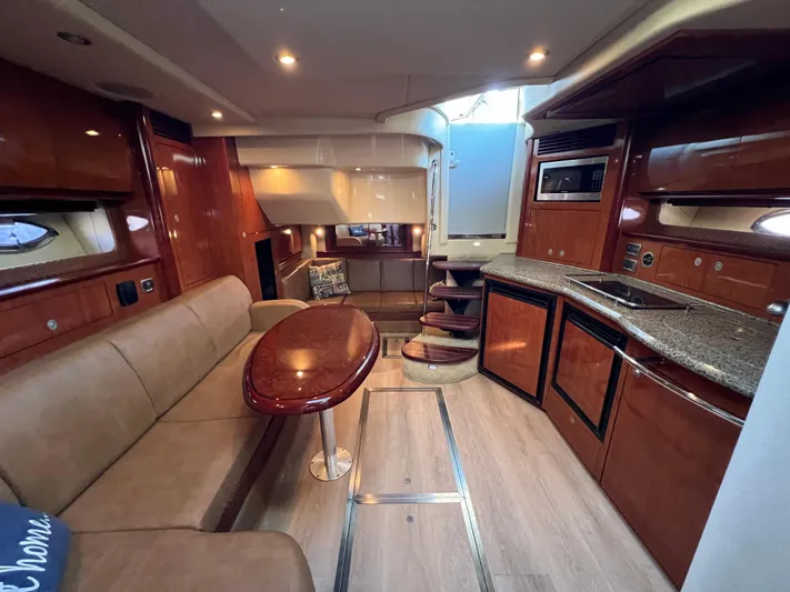  Yacht Photos Pics Luxurious interior of 2005 Sea Ray 390 Sundancer yacht with wood finishes and modern amenities.