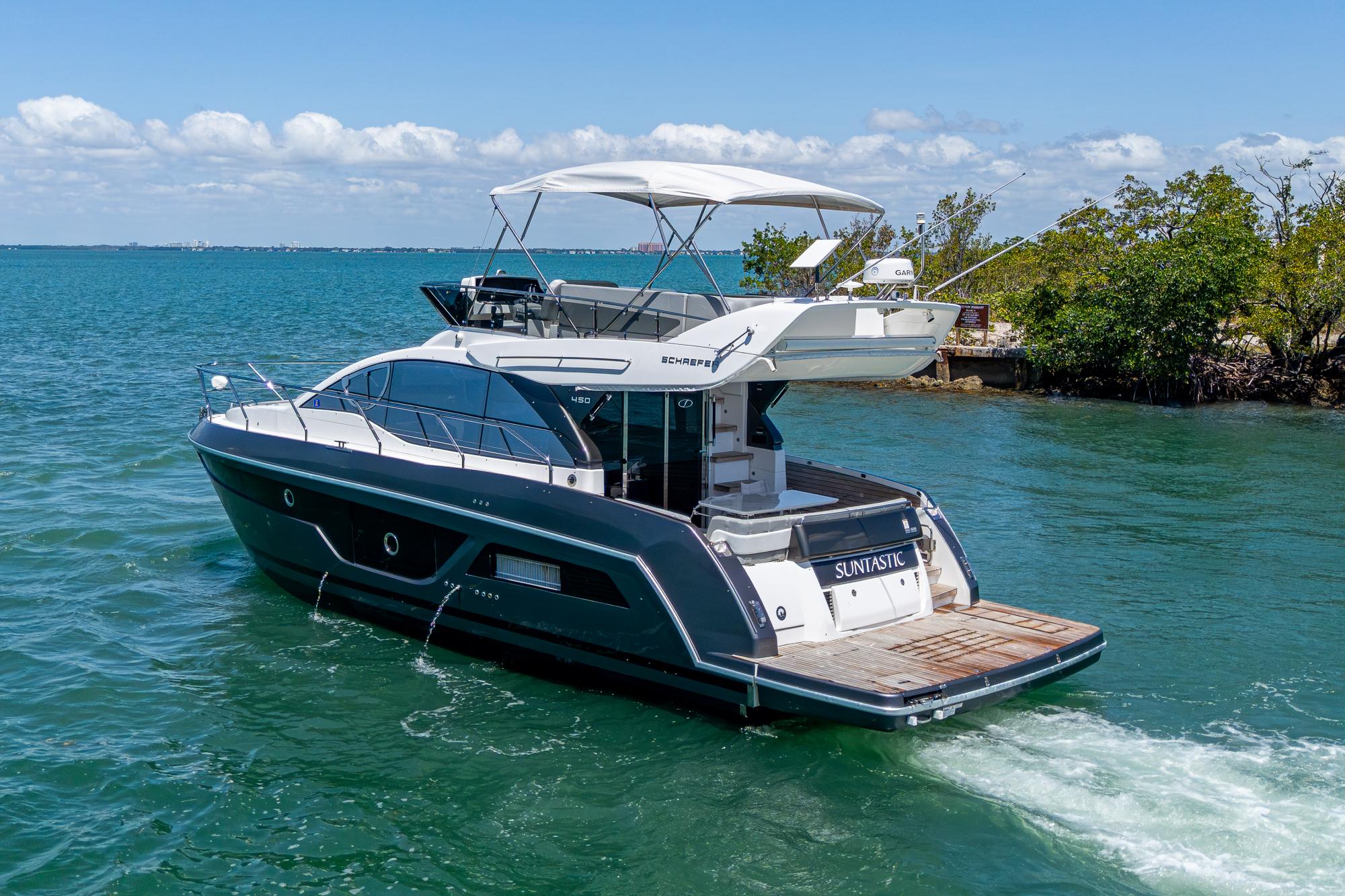 2023 Schaefer 450 yacht cruising on a sunny day in clear blue waters.
