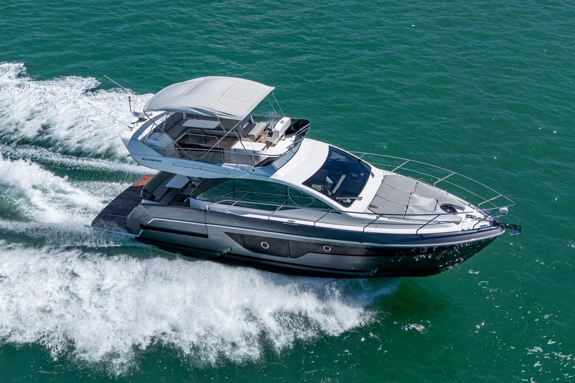2023 Schaefer 450 yacht cruising on open water, showcasing sleek design and luxury features.
