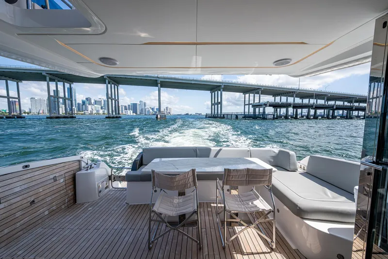 Suntastic Yacht Photos Pics Luxury Schaefer 450 yacht cruising under a bridge, 2023 model, with elegant deck seating.