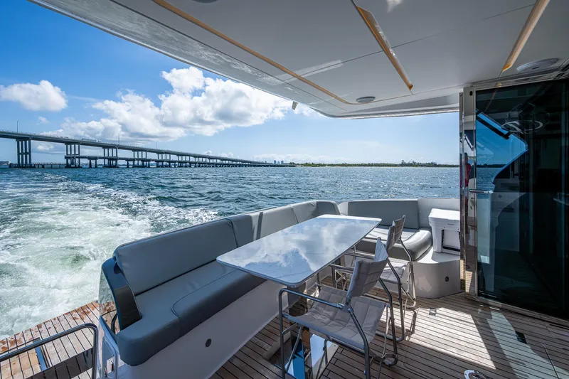 Suntastic Yacht Photos Pics Luxury Schaefer 450 yacht deck with seating, table, and ocean view, 2023 model.