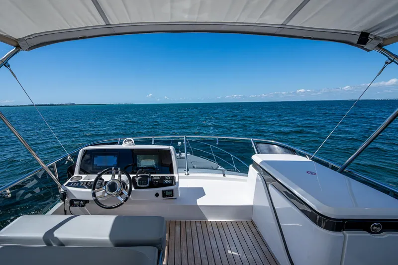 Suntastic Yacht Photos Pics Schaefer 450 yacht helm with ocean view, 2023 model, featuring modern controls and seating.