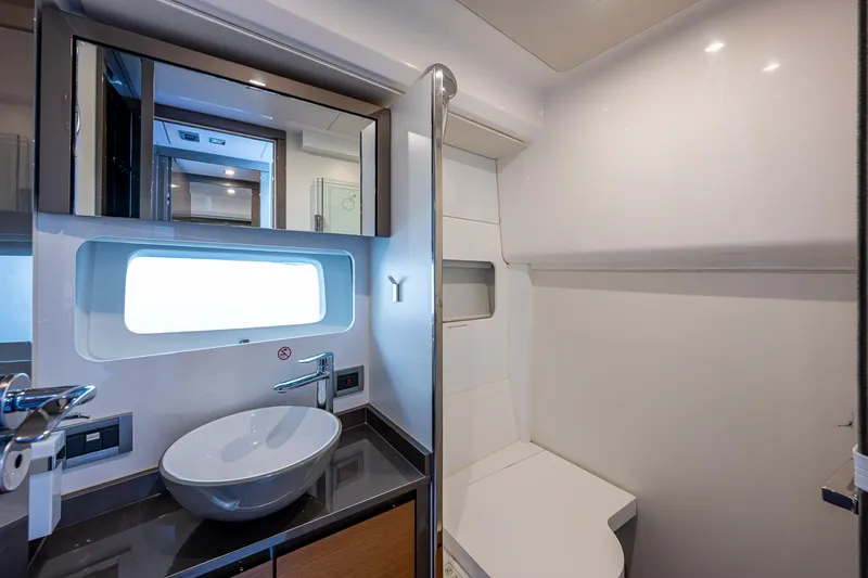 Suntastic Yacht Photos Pics Modern bathroom interior in 2023 Schaefer 450 yacht, featuring sleek sink and compact design.