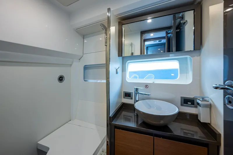 Suntastic Yacht Photos Pics Modern bathroom interior in 2023 Schaefer 450 yacht, featuring sleek sink and mirror.