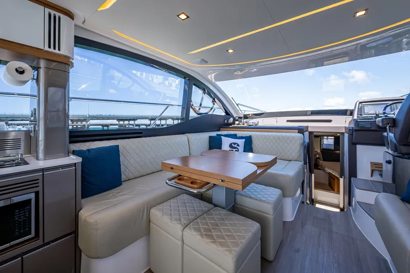 Suntastic Yacht Photos Pics Luxurious interior of 2023 Schaefer 450 yacht with modern seating and dining area.