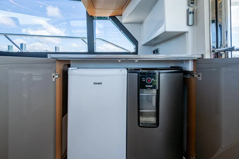Suntastic Yacht Photos Pics Compact kitchen area on a 2023 Schaefer 450 yacht with fridge and cooler.
