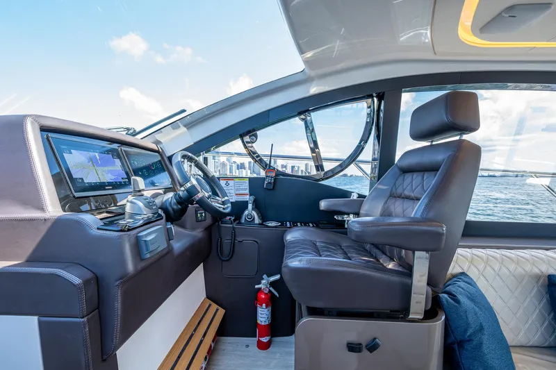 Suntastic Yacht Photos Pics Interior of 2023 Schaefer 450 yacht cockpit with modern controls and leather seating.