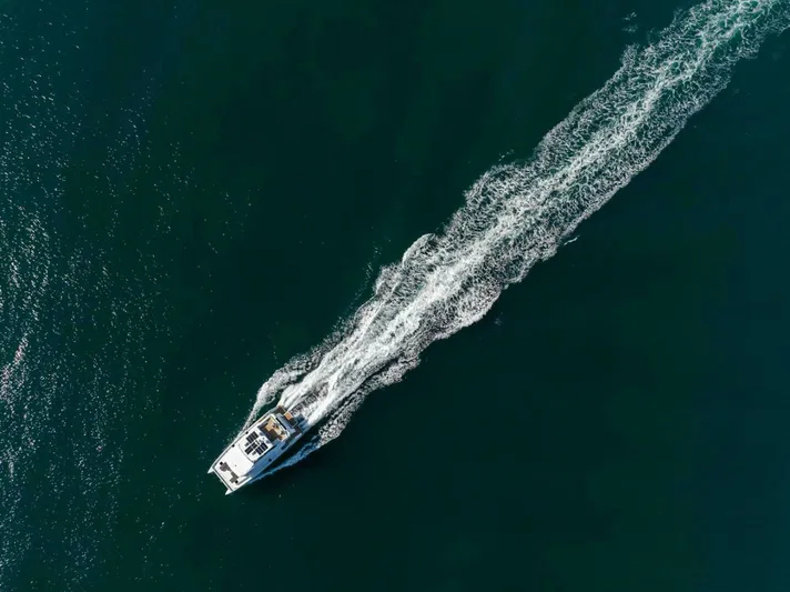 62 Iliad 2026 Yacht Photos Pics Aerial view of ILIAD 62 yacht cruising on open water, 2026 model.